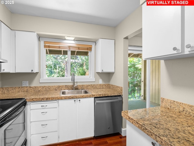 6801 SW Terri Ct Unit 60, Portland, OR 97225 - kitchen with stainless steel appliances, dark wood finished floors, white cabinetry, and light countertops