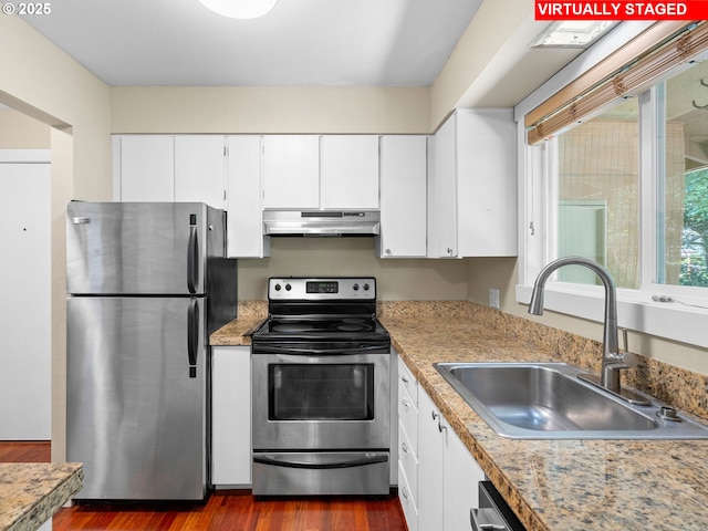 6801 SW Terri Ct Unit 60, Portland, OR 97225 - kitchen featuring stainless steel appliances, under cabinet range hood, white cabinetry, light countertops, and dark wood-type flooring