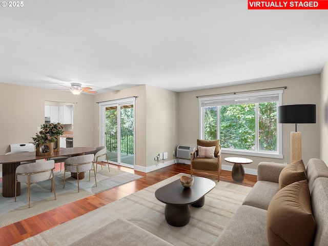 6801 SW Terri Ct Unit 60, Portland, OR 97225 - living area with wood finished floors, plenty of natural light, a wall unit AC, and ceiling fan