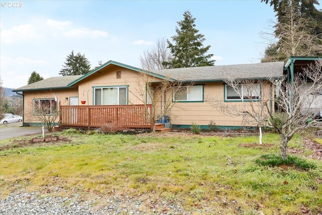 744 NE Craig St, Myrtle Creek, OR 97457 - ranch-style house featuring a wooden deck, a front yard, and a shingled roof