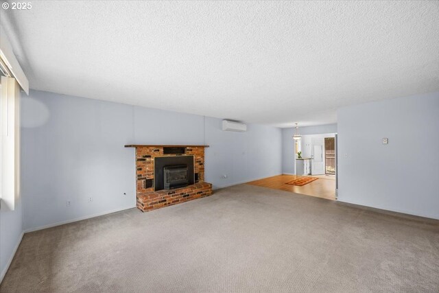 744 NE Craig St, Myrtle Creek, OR 97457 - unfurnished living room with a wall unit AC, carpet, a textured ceiling, and baseboards
