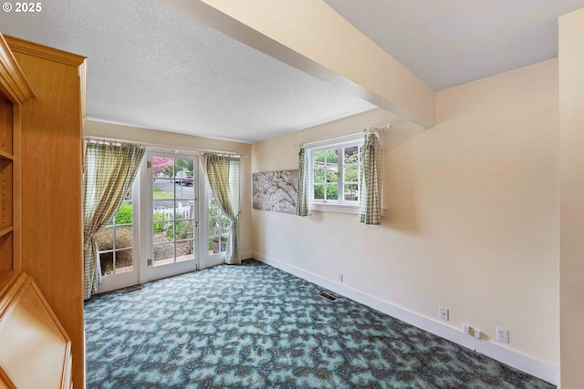 spare room with carpet flooring and baseboards