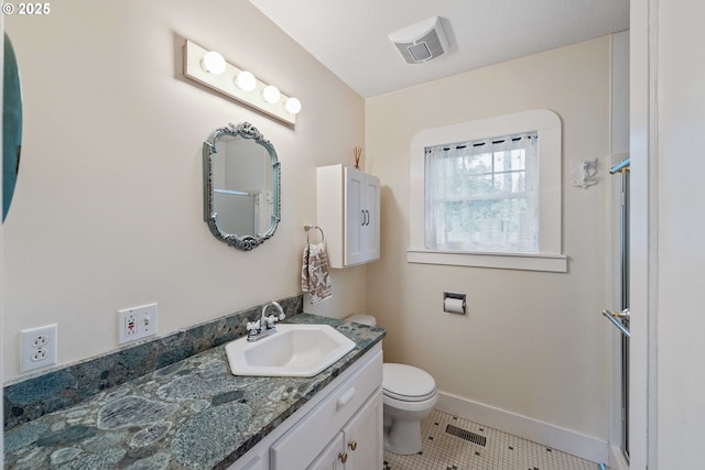 full bathroom featuring tile patterned floors, toilet, vanity, baseboards, and a shower