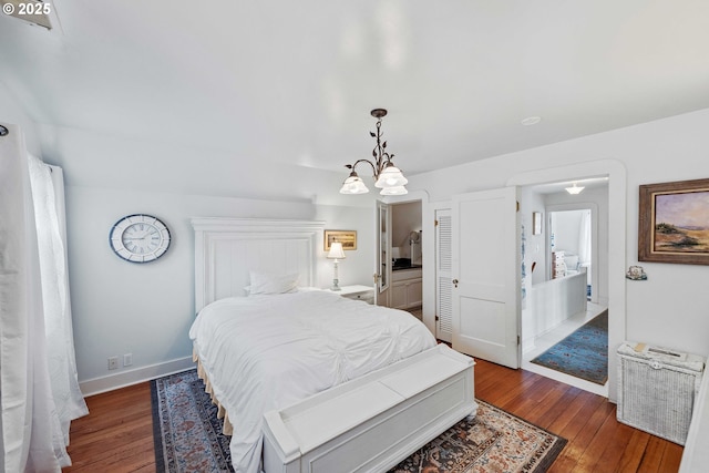 bedroom with hardwood / wood-style flooring, baseboards, and a chandelier