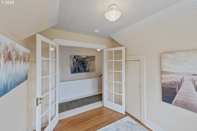 interior space featuring wood finished floors and french doors