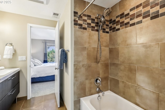 full bathroom featuring connected bathroom, vanity, washtub / shower combination, and tile patterned flooring