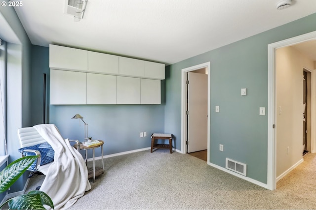 living area featuring light carpet and baseboards