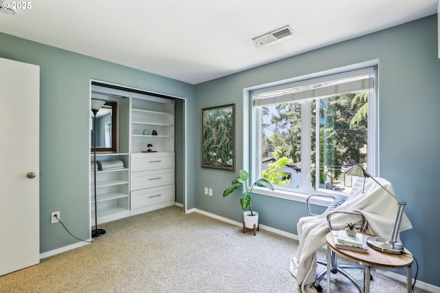 sitting room with light colored carpet and baseboards
