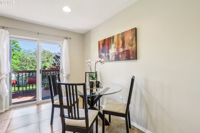 tiled dining room featuring baseboards and recessed lighting