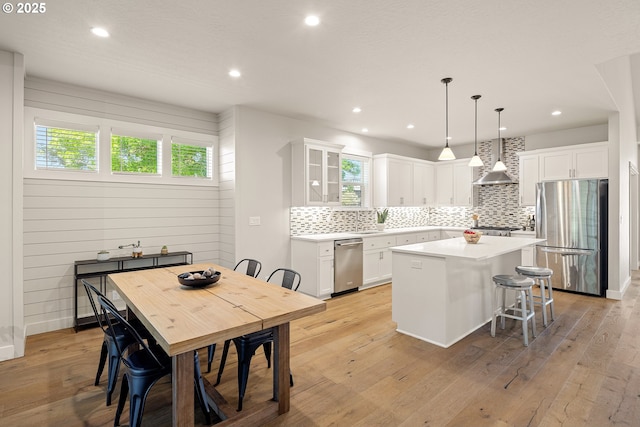1408 Taylor St, Eugene, OR 97402 - kitchen with stainless steel appliances, a breakfast bar, decorative backsplash, a kitchen island, and recessed lighting