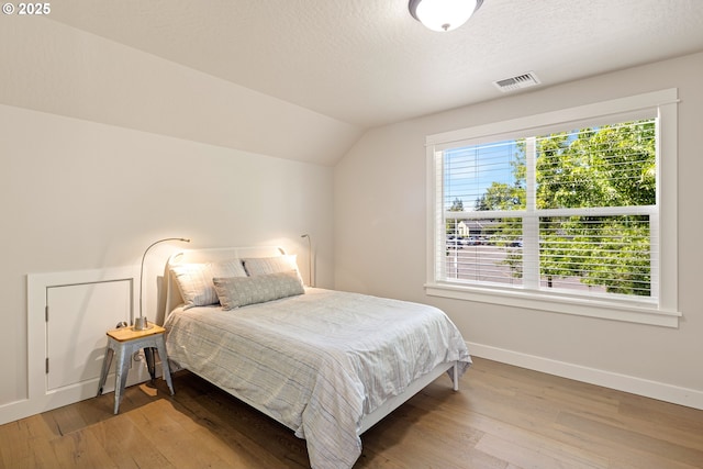 1408 Taylor St, Eugene, OR 97402 - bedroom with baseboards, hardwood / wood-style floors, vaulted ceiling, and a textured ceiling