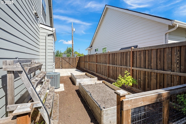 1408 Taylor St, Eugene, OR 97402 - fenced backyard with central AC, a garden, and a gate
