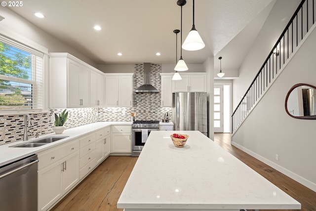 1408 Taylor St, Eugene, OR 97402 - kitchen with appliances with stainless steel finishes, wall chimney range hood, a sink, a center island, and decorative backsplash
