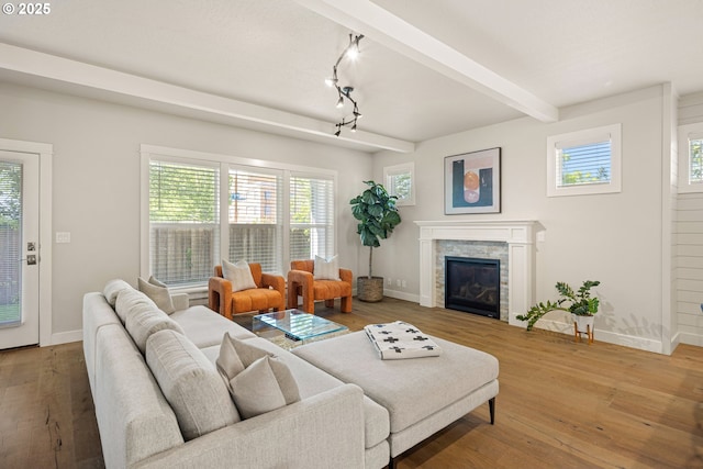 1408 Taylor St, Eugene, OR 97402 - living room with baseboards, hardwood / wood-style floors, beamed ceiling, and a stone fireplace