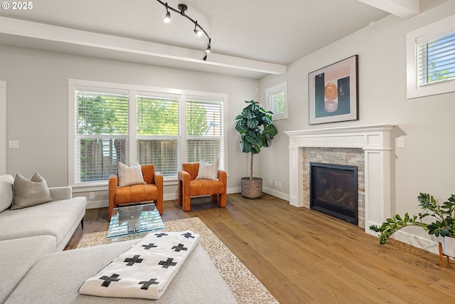 1408 Taylor St, Eugene, OR 97402 - living room with wood finished floors, a glass covered fireplace, baseboards, and rail lighting