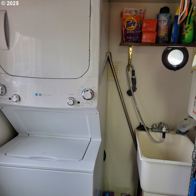 washroom featuring laundry area and stacked washer / drying machine