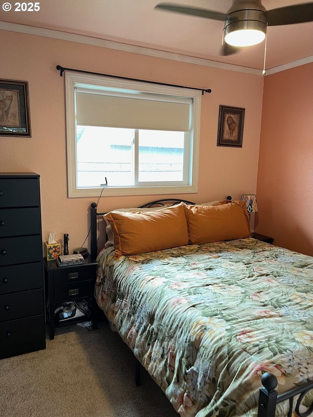 carpeted bedroom with ceiling fan and crown molding