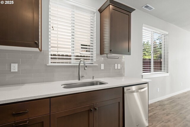 15519 NE 108th Way, Vancouver, WA 98682 - kitchen featuring stainless steel dishwasher, a sink, decorative backsplash, and light wood finished floors