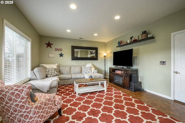 living area featuring visible vents, baseboards, recessed lighting, and wood finished floors