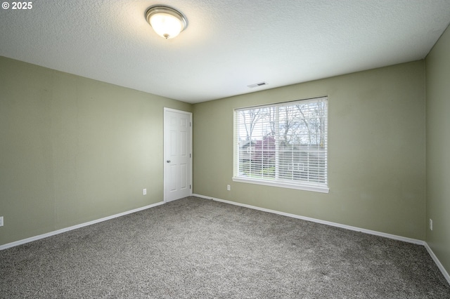 carpeted empty room featuring visible vents, baseboards, and a textured ceiling