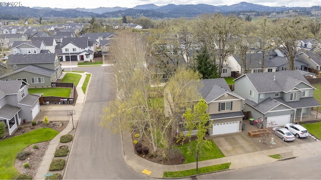 drone / aerial view featuring a residential view and a mountain view