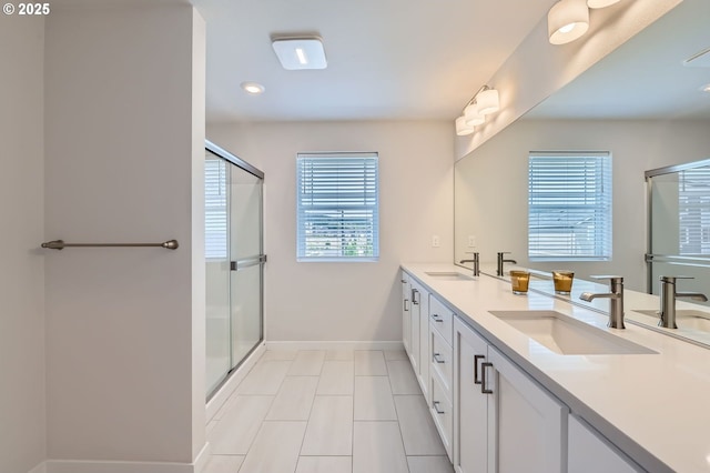 12935 SW Tabor Ter, Beaverton, OR 97007 - full bathroom featuring a shower with door, double vanity, recessed lighting, and tile patterned flooring