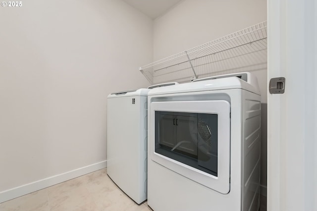 12935 SW Tabor Ter, Beaverton, OR 97007 - laundry area with washer and clothes dryer and baseboards