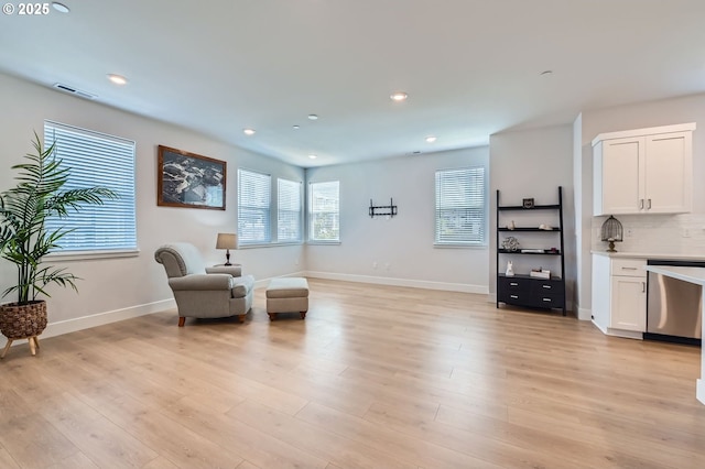 12935 SW Tabor Ter, Beaverton, OR 97007 - living area featuring healthy amount of natural light, light wood-style floors, and recessed lighting