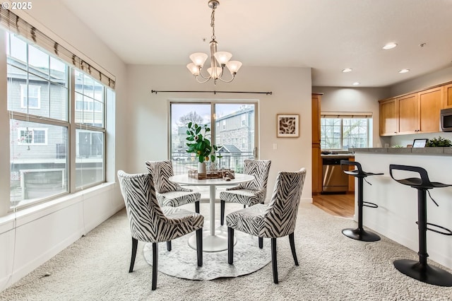 dining room with a chandelier, recessed lighting, light colored carpet, and baseboards