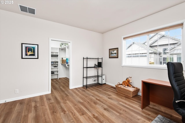 home office with light hardwood / wood-style floors