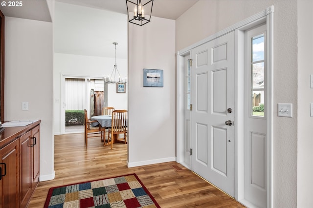 entryway featuring a chandelier and hardwood / wood-style flooring