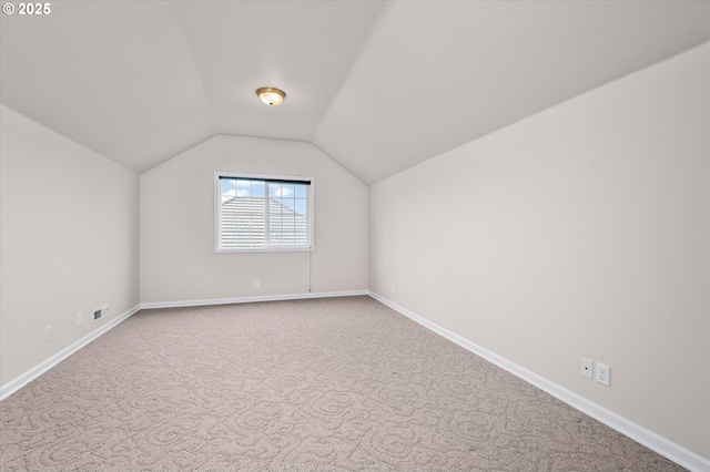 bonus room featuring vaulted ceiling and carpet floors