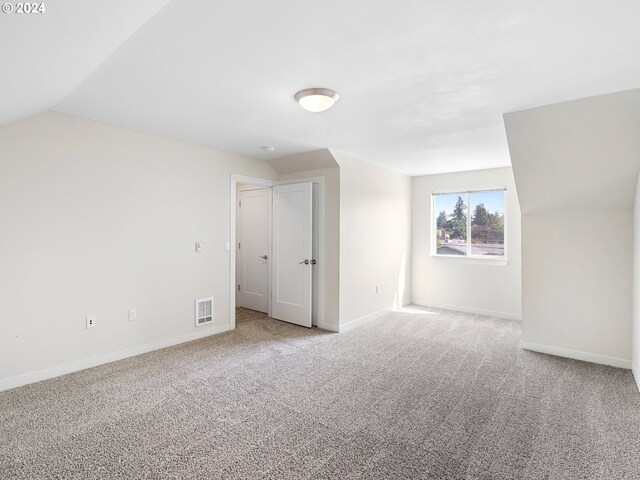 10831 E Burnside St, Portland, OR 97216 - additional living space featuring carpet floors, baseboards, and lofted ceiling