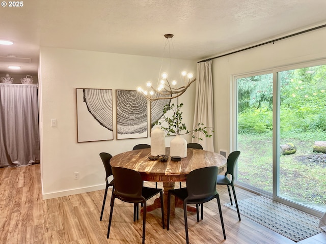 23610 E Gumjuwac Rd, Brightwood, OR 97011 - dining room featuring light wood-style floors, a chandelier, and baseboards