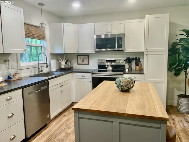 23610 E Gumjuwac Rd, Brightwood, OR 97011 - kitchen with appliances with stainless steel finishes, a sink, butcher block counters, light wood-type flooring, and recessed lighting