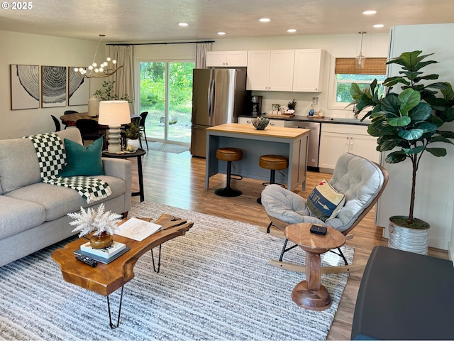23610 E Gumjuwac Rd, Brightwood, OR 97011 - living room with plenty of natural light, light wood finished floors, a chandelier, and recessed lighting