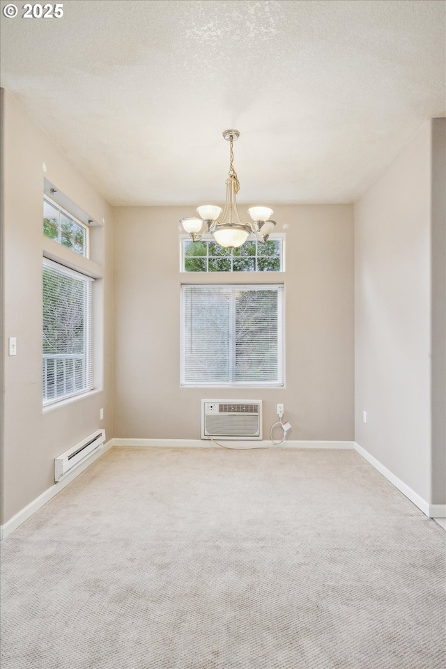 14781 SW Beard Rd, Beaverton, OR 97007 - unfurnished room with baseboard heating, a wall mounted air conditioner, a chandelier, carpet flooring, and a textured ceiling