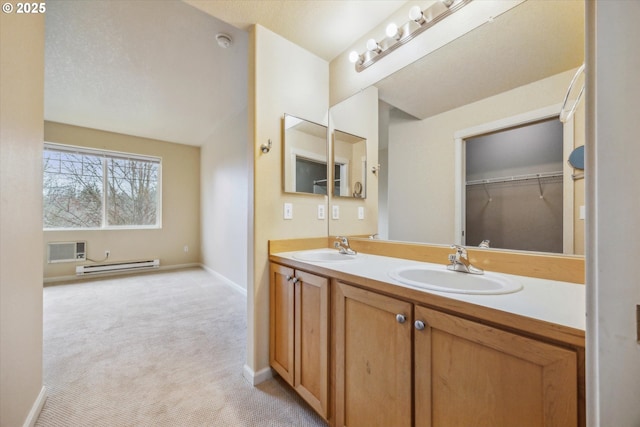14781 SW Beard Rd, Beaverton, OR 97007 - bathroom with a baseboard heating unit, double vanity, and a wall unit AC