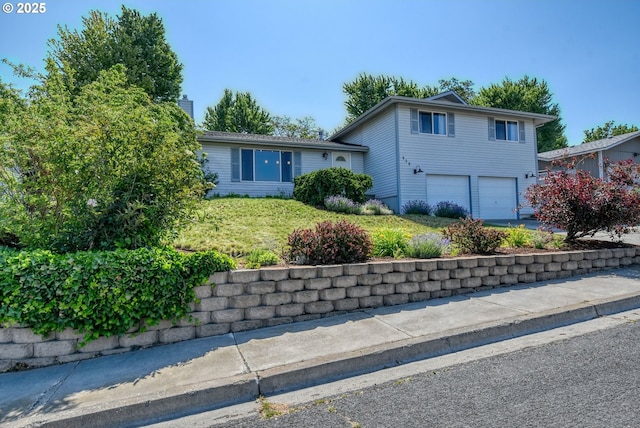 458 NW 21st St, Pendleton, OR 97801 - split level home featuring a garage, a chimney, and a front lawn