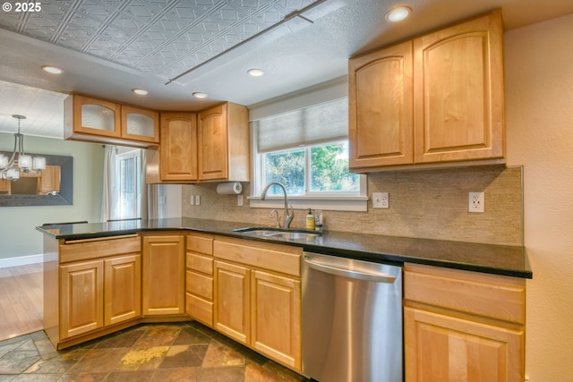 458 NW 21st St, Pendleton, OR 97801 - kitchen with stainless steel dishwasher, backsplash, dark countertops, a peninsula, and an ornate ceiling