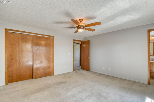 458 NW 21st St, Pendleton, OR 97801 - unfurnished bedroom featuring light colored carpet, a textured ceiling, connected bathroom, a closet, and a ceiling fan