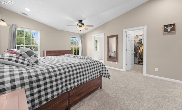 carpeted bedroom featuring vaulted ceiling, a spacious closet, ceiling fan, and baseboards