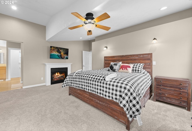 carpeted bedroom featuring a warm lit fireplace, ceiling fan, baseboards, and recessed lighting