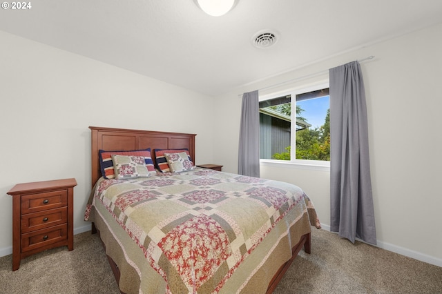 bedroom featuring baseboards, visible vents, and light colored carpet