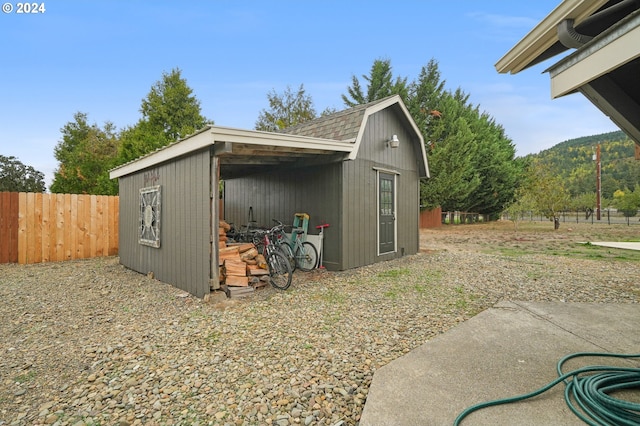 view of shed featuring fence