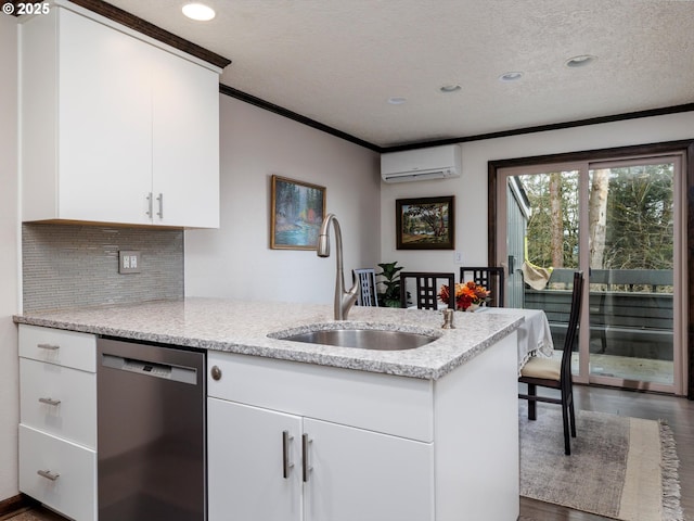 kitchen featuring ornamental molding, a wall mounted AC, a sink, stainless steel dishwasher, and a peninsula