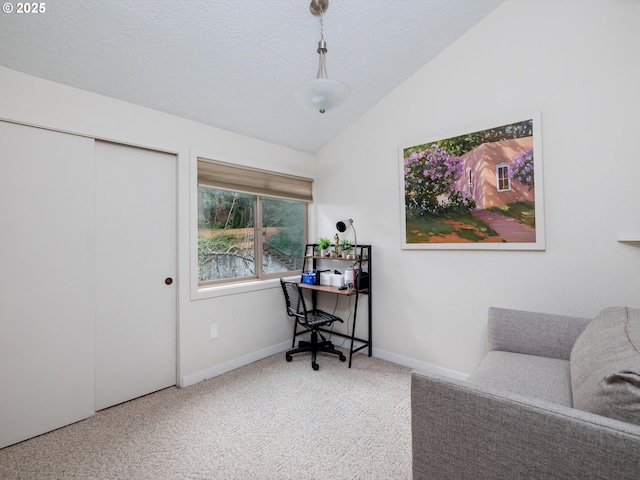 carpeted office featuring lofted ceiling, baseboards, and a textured ceiling