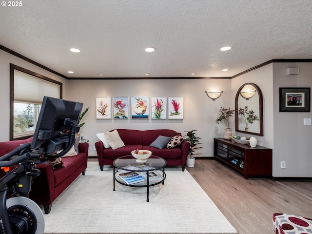 living room with wood finished floors, baseboards, recessed lighting, ornamental molding, and a textured ceiling