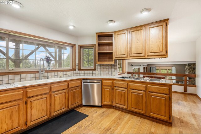 21075 NE Turner Ln, Hillsboro, OR 97123 - kitchen featuring a sink, tile countertops, dishwasher, a peninsula, and backsplash
