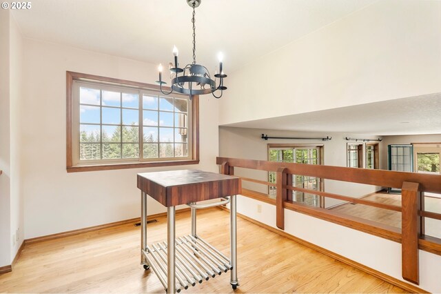 21075 NE Turner Ln, Hillsboro, OR 97123 - staircase featuring a chandelier, wood finished floors, and baseboards